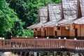 Beach resort with nipa hut cottages and forest as background Royalty Free Stock Photo