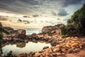 Beach rocks lagoon tropical landscape with palm trees and round stones with sunset sky vibrant colors in Sri Lanka Royalty Free Stock Photo