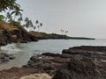 Beach and rocks with palm trees Royalty Free Stock Photo