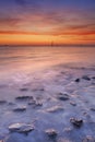 Beach with rocks at sunset in Zeeland, The Netherlands