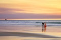 Beach Romantic Young Couple Walking Edge of Sea at Sunset