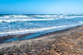 Beach with rough sea in a sunny day Royalty Free Stock Photo