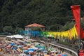 Beach with row of colorful flags and umbrellas