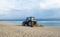 Beach on Rugen Island, Germany. Tractor grooming sand on the beach at Baltic Sea