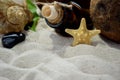 Beach sand, a bottle with a letter inside, seashells and starfish. Royalty Free Stock Photo