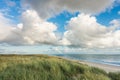 Beach with sand dunes and marram grass, blue sky and clouds in soft evening sunset light. Hvidbjerg Strand, Blavand Royalty Free Stock Photo