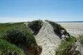 Beach with sand dunes and a path to the sea