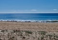 Beach with sand, dunes, plants and blue ocean