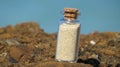 Beach sand in glass bottle, standing on beach rock. Mana island, Fiji Royalty Free Stock Photo