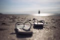 on beach on the sand a pair of beach slippers stands close-up and the background is blurred at sunset, the photo is Royalty Free Stock Photo