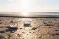 on beach on the sand a pair of beach slippers stands close-up and the background is blurred at sunset, the photo is Royalty Free Stock Photo