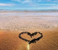 Romantic heart symbol on beach sand sea water wave sunny day blue sky , summer holiday background