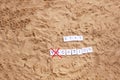 Beach sand with toys for the baby, water, the word holi stay in colored letters Royalty Free Stock Photo