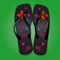 Beach sandals, black flip flops with a bright pattern on green b Royalty Free Stock Photo