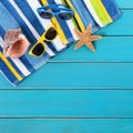 Beach scene blue decking sunglasses, towel, starfish, summer background square Royalty Free Stock Photo