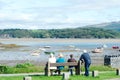 Beach scene at Borth y Gest, north Wales. Holiday makers enjoy the view over a peaceful bay