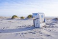 Beach scene with beach chair on the island `Amrum`, North Sea, Germany. Royalty Free Stock Photo