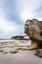 Beach scene with clouds and rocks in foreground Royalty Free Stock Photo