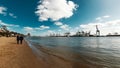 Beach scene at the Elbe with container harbor in Hamburg.