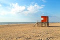 Beach scene. Red lifeguard tower in foreground. Atlantic coast. Mar de las Pampas. Argentina.