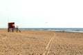 Beach scene. Red lifeguard tower in foreground. Atlantic coast. Mar de las Pampas. Argentina.