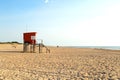 Beach scene. Red lifeguard tower in foreground. Atlantic coast. Mar de las Pampas. Argentina.