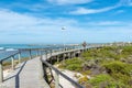 Beach scene in Struisbaai with the boardwalk, boats and harbor