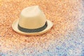 Sun hat lying on sea coquina shells on the beach