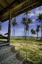 Beach scenery from abandon house. coconut tree, the sea and the blue sky Royalty Free Stock Photo