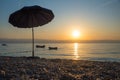 Beach scenery with sunshade and boats in the early morning, Moscenicka Draga croatia Royalty Free Stock Photo