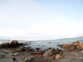 Beach sea scene view with deep blue sky and brown beach sand and stones Royalty Free Stock Photo