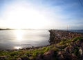 Beach sea scene view with deep blue sky and brown beach sand and stones Royalty Free Stock Photo