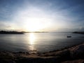 Beach sea scene view with deep blue sky and brown beach sand and stones Royalty Free Stock Photo