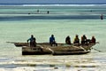 beach seaweed people and boat in tanzania zanzibar