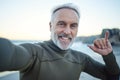 Beach, selfie and a happy elderly surfer man at water on weekend morning. Freedom, ocean and happiness, fun on Royalty Free Stock Photo