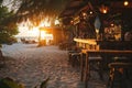 A beach shack bar at sunset, with a few tables on the sand, Ai generated Royalty Free Stock Photo