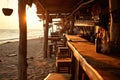 A beach shack bar at sunset, with a few tables on the sand, Ai generated Royalty Free Stock Photo