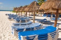 Beach shelters and chairs in the sun on a beach