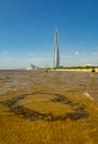 A beach on the shores of the Gulf of Finland overlooking the Lakhta Center, a skyscraper in St. Petersburg that will house the