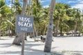 A beach sign posted at the beachfront. A nudist beach or naturist resort