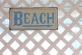 Beach sign on a white trellis