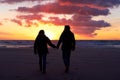 Beach, silhouette and couple holding hands at sunset while walking, bonding and enjoying freedom. Love, shadow and man Royalty Free Stock Photo