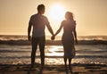 Beach silhouette, couple holiday and sunset with love, hold hands and love together, support and holiday. Man, woman and Royalty Free Stock Photo