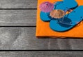 Beach slippers, towel on wood background. Concept of leisure Royalty Free Stock Photo