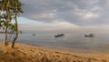 Beach and small fishing boats in sea