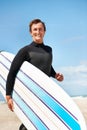 Beach, smile and man with surfboard for exercise, fitness workout or body health in summer outdoor. Surfer, wetsuit and