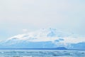 Beach with snowy moutain background in a sunny day Royalty Free Stock Photo