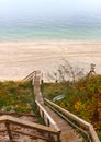 Beach With Staircase That Ambles Down the Cliff Royalty Free Stock Photo