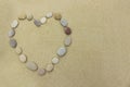 Beach stones in the shape of a heart on a sandy beach Royalty Free Stock Photo