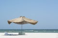 Beach straw umbrella from the sun on the beach with sun beds, on the background of the sea and blue sky, Royalty Free Stock Photo